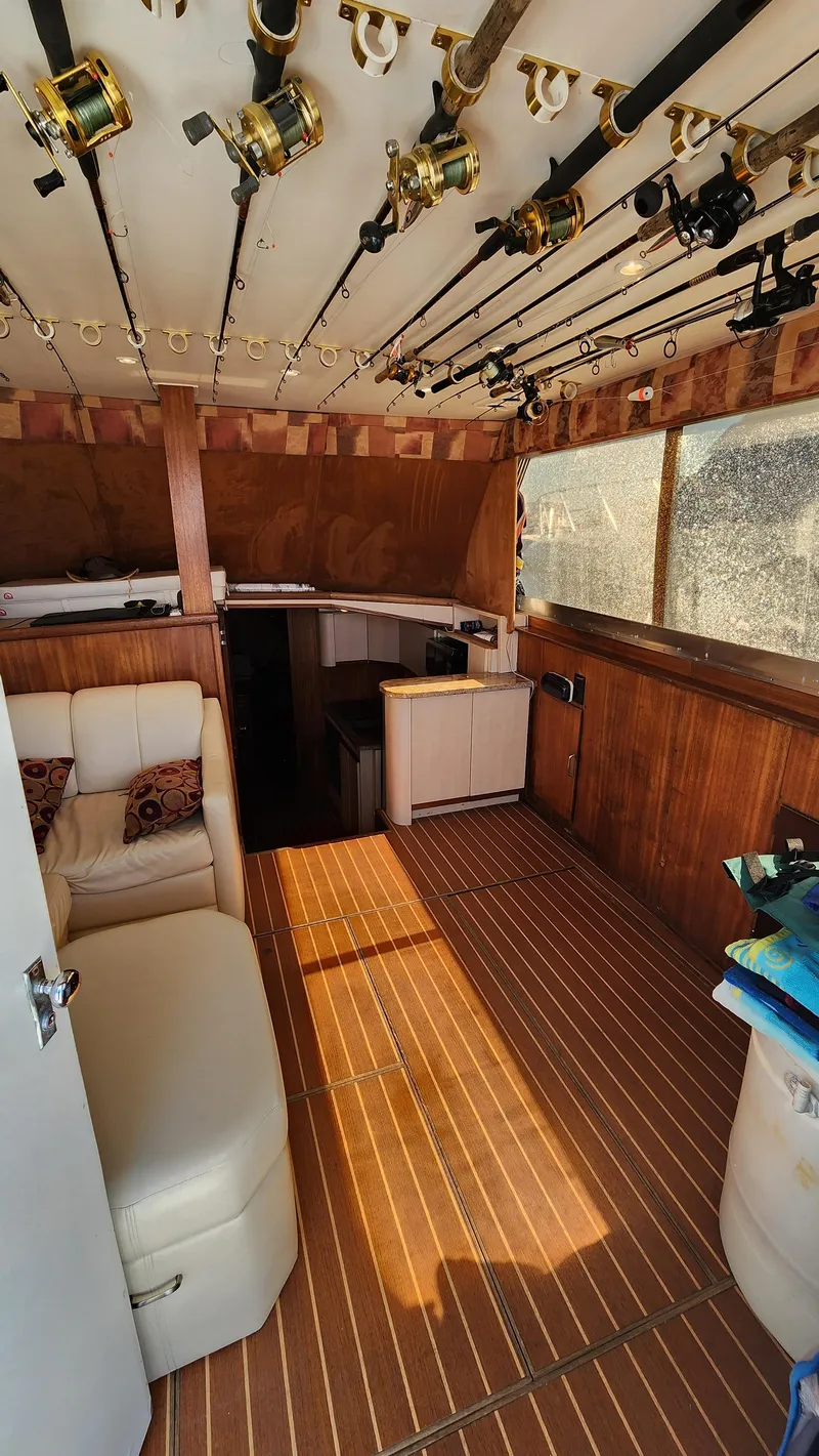 Slide: The Image of Interior of 1969 Hatteras 36 Sport Fisherman with fishing rods and wooden flooring. - 23