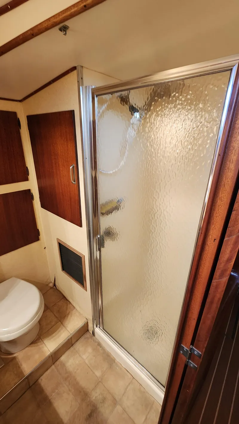 Slide: The Image of Bathroom interior of 1969 Hatteras 36 Sport Fisherman with shower and toilet. - 28