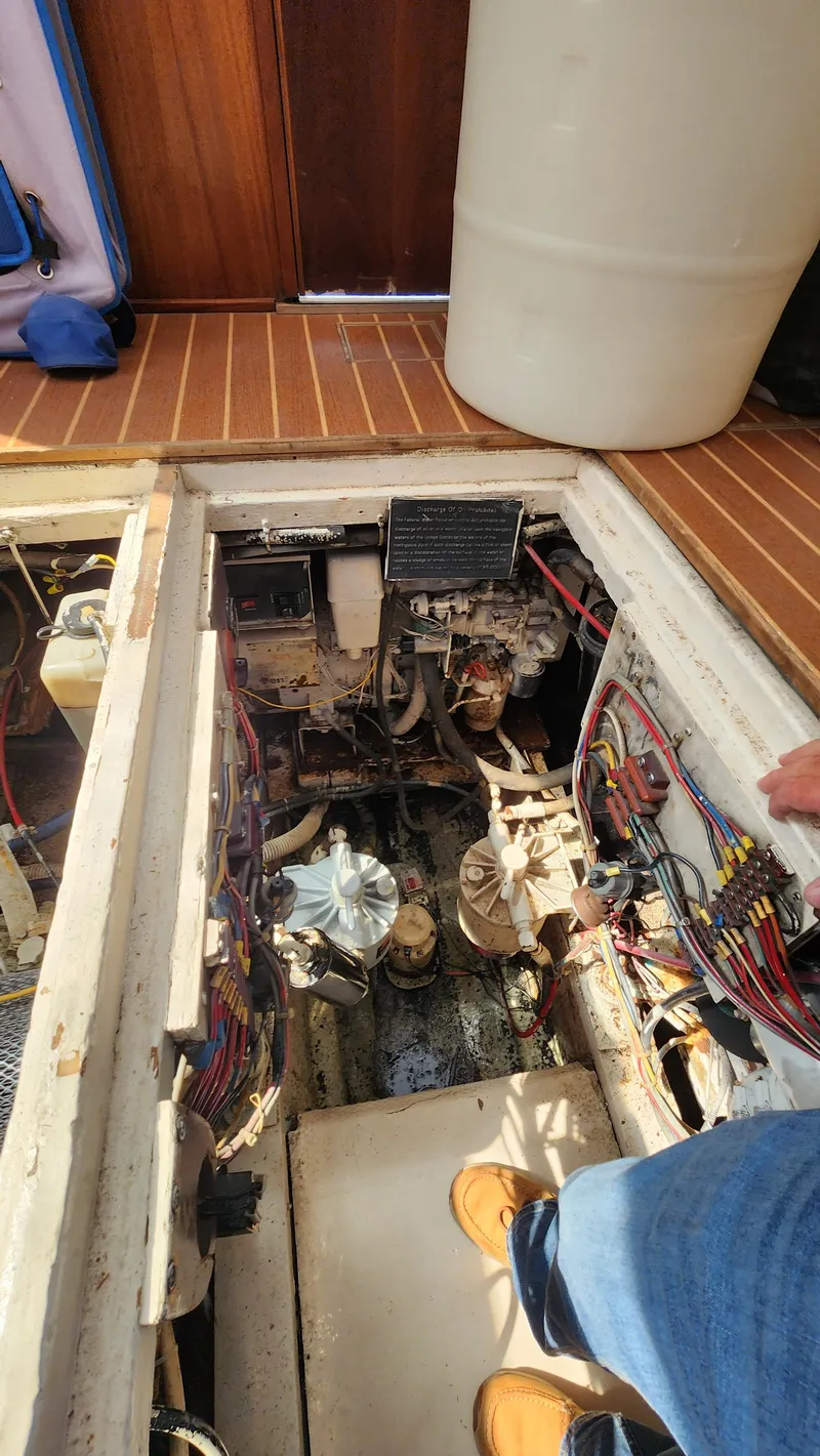 Slide: The Image of Engine room of a 1969 Hatteras 36 Sport Fisherman boat, showing mechanical components. - 32