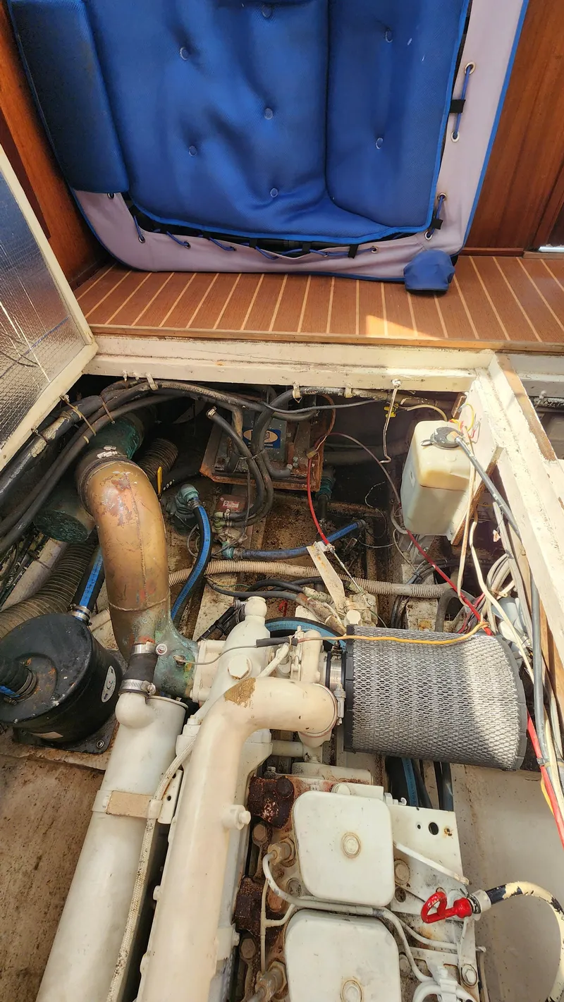 Slide: The Image of Engine compartment of a 1969 Hatteras 36 Sport Fisherman boat, showcasing mechanical components. - 33
