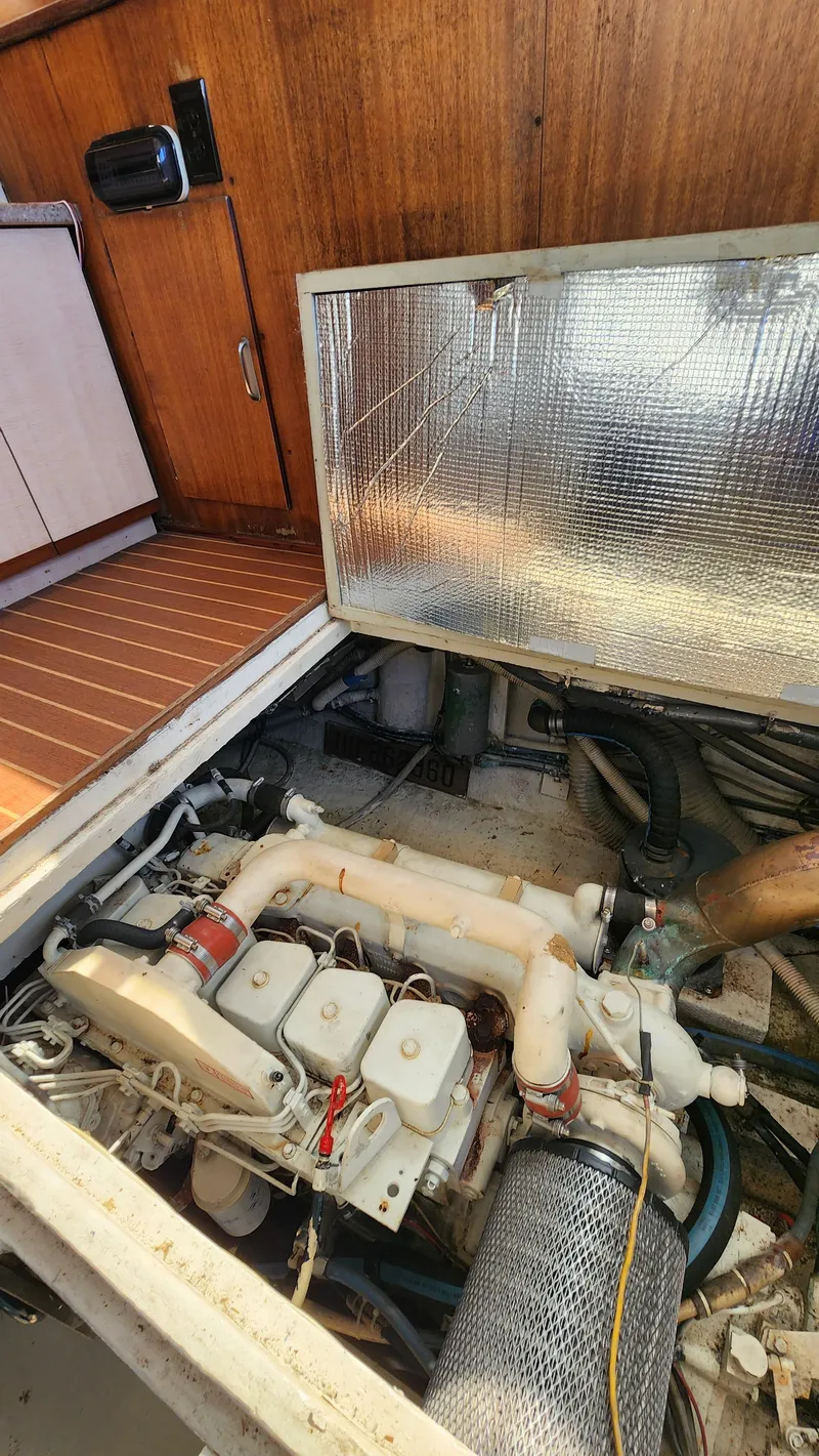 Slide: The Image of Engine compartment of a 1969 Hatteras 36 Sport Fisherman boat, showcasing mechanical components. - 34