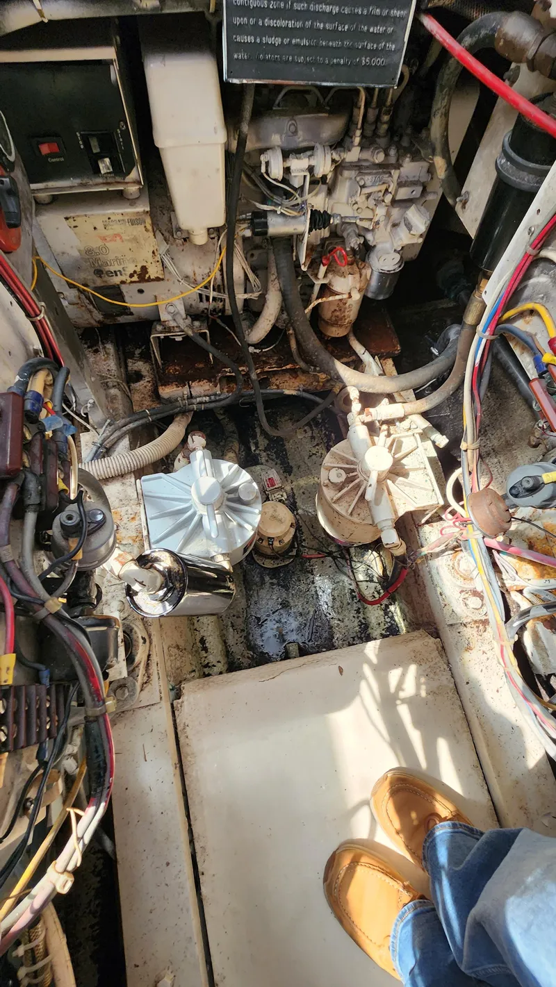 Slide: The Image of Engine room of a 1969 Hatteras 36 Sport Fisherman boat, showing mechanical components. - 36