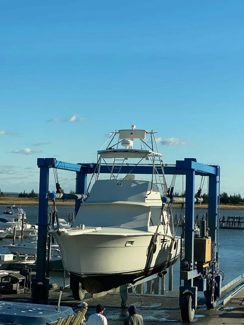 Slide: The Image of 1969 Hatteras 36 Sport Fisherman boat being lifted at a marina. - 39