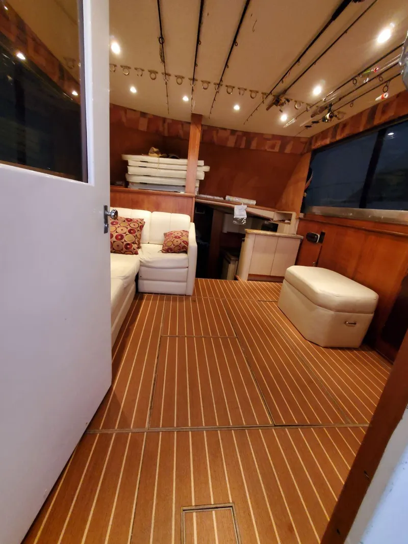Slide: The Image of 1969 Hatteras 36 Sport Fisherman interior with wood flooring and cozy seating area. - 40