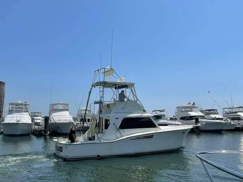 Slide: The Image of 1969 Hatteras 36 Sport Fisherman boat in a marina, surrounded by other vessels. - 8