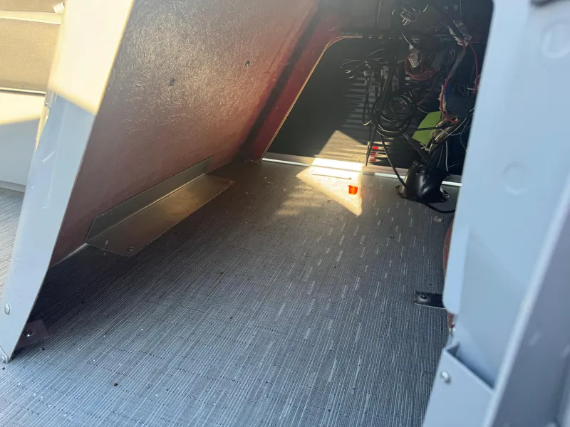 Slide: The Image of Interior view of 2023 Bennington 23SX Swingback boat, showing wiring and flooring details. - 6