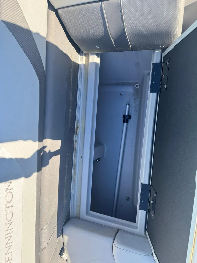 Slide: The Image of Open storage compartment in 2023 Bennington 23SX Swingback boat. - 7