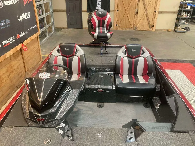 Slide: The Image of 2022 Ranger Z520R boat interior with red and gray seats in a garage setting. - 10
