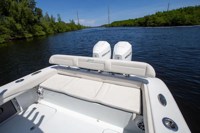 Slide: The Image of 2022 Yellowfin 26 Hybrid boat with dual Mercury engines on a scenic river. - 10