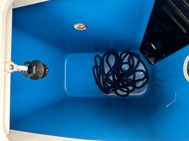 Slide: The Image of Blue storage compartment with coiled rope in 2018 Everglades 273CC boat. - 12