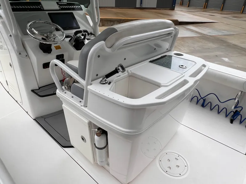 Slide: The Image of 2018 Everglades 273CC boat interior with helm and storage compartments. - 13