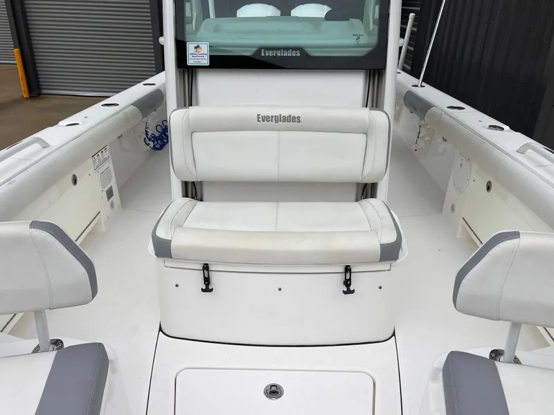 Slide: The Image of 2018 Everglades 273CC boat interior with white seating and sleek design. - 17