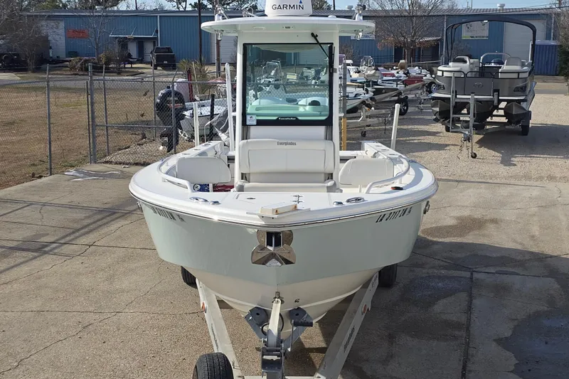 Slide: The Image of 2018 Everglades 273 Center Console boat on trailer in a marina setting. - 21