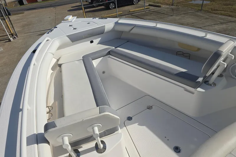 Slide: The Image of 2018 Everglades 273 Center Console boat interior with cushioned seating and storage. - 29