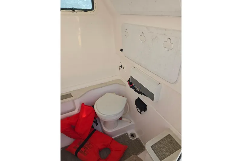 Slide: The Image of Interior of 2018 Everglades 273 Center Console boat with life jackets and toilet. - 32