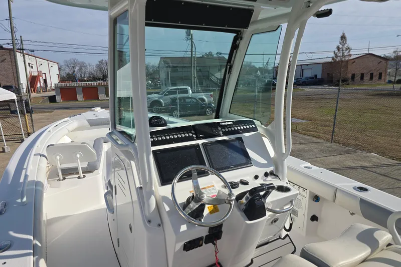 Slide: The Image of 2018 Everglades 273 Center Console boat interior with steering and navigation controls. - 33