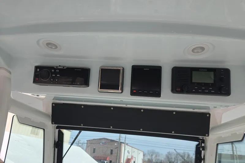 Slide: The Image of 2018 Everglades 273 Center Console dashboard with Garmin electronics and Fusion stereo system. - 35