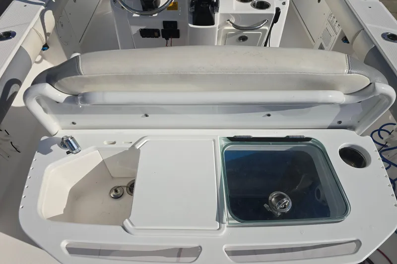 Slide: The Image of 2018 Everglades 273 Center Console boat interior with seating and storage compartments. - 37