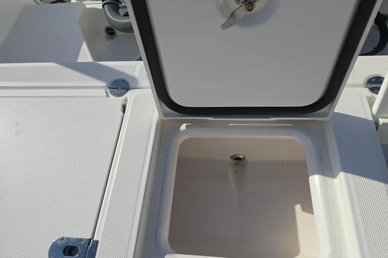 Slide: The Image of Open storage compartment on 2018 Everglades 273 Center Console boat. - 40