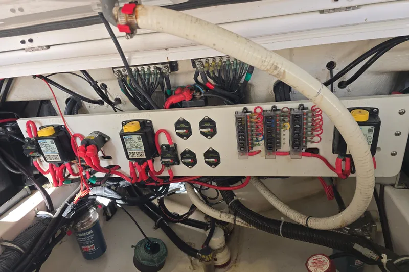 Slide: The Image of Electrical panel of a 2018 Everglades 273 Center Console boat, showcasing wiring and fuses. - 46
