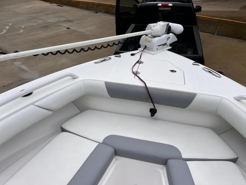 Slide: The Image of 2018 Everglades 273CC boat with white and gray seating, featuring a mounted trolling motor. - 6