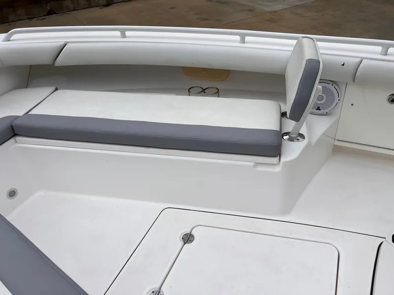 Slide: The Image of 2018 Everglades 273CC boat interior with cushioned seating and storage compartments. - 7