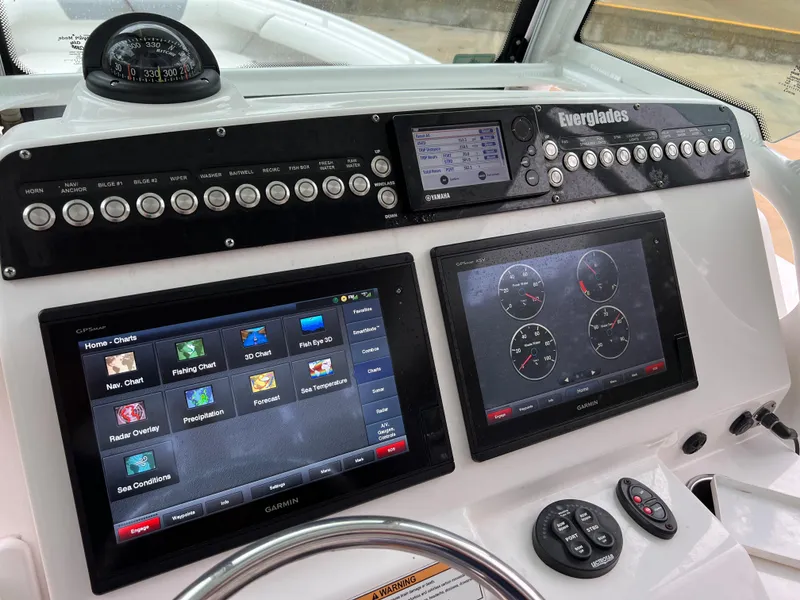 Slide: The Image of 2018 Everglades 273CC boat dashboard with advanced navigation and control systems. - 8