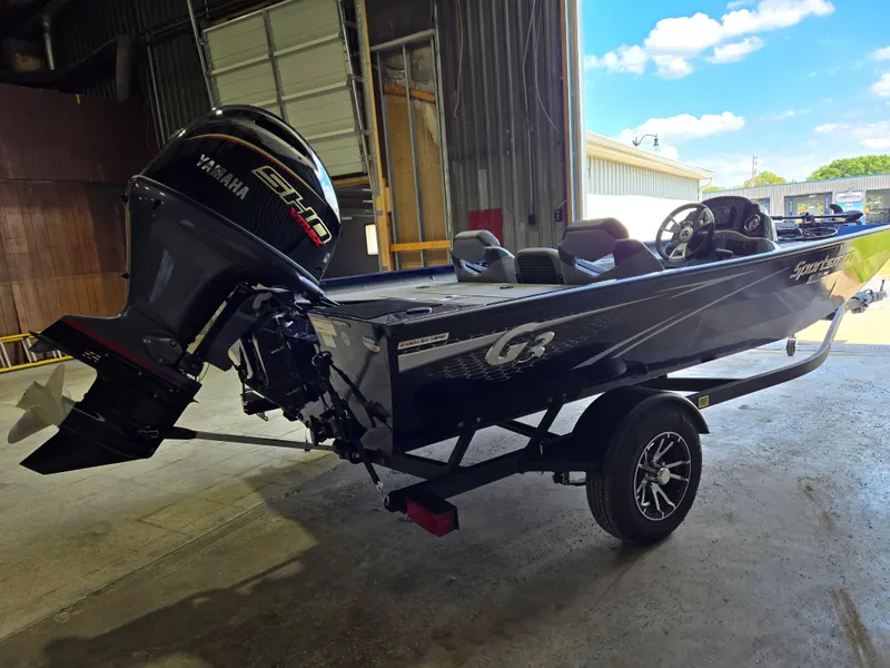 Slide: The Image of 2025 G3 Sportsman 1710 boat with Yamaha engine in a garage setting. - 2
