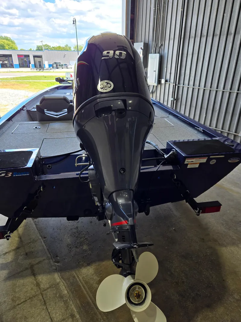 Slide: The Image of 2025 G3 Sportsman 1710 boat with powerful outboard motor in a garage setting. - 3