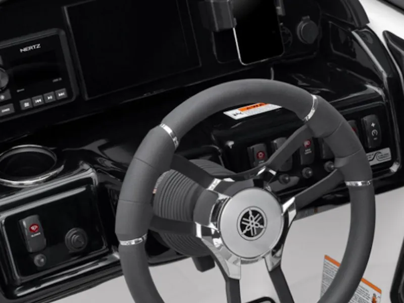 Slide: The Image of Steering wheel and dashboard of 2025 Yamaha Boats 195S, featuring modern controls and design. - 6