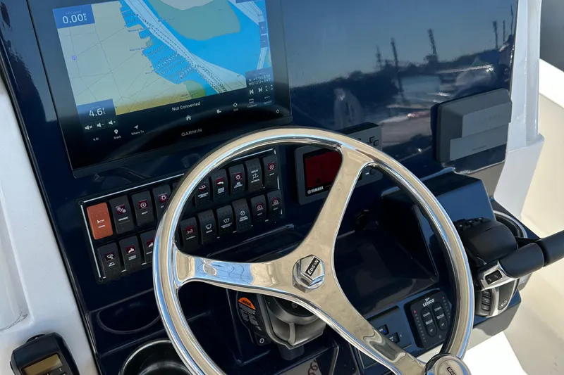 Slide: The Image of 2024 Pursuit S 268 Sport boat dashboard with navigation display and steering wheel. - 18