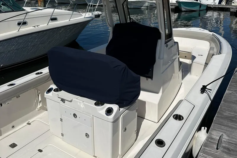 Slide: The Image of 2024 Pursuit S 268 Sport boat interior at marina dock. - 2