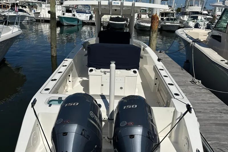 Slide: The Image of 2024 Pursuit S 268 Sport boat with twin Yamaha 150 engines docked at marina. - 5
