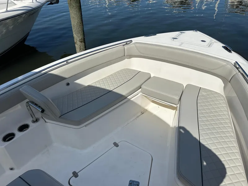 Slide: The Image of 2024 Pursuit S 268 Sport boat interior with cushioned seating and cup holders. - 8