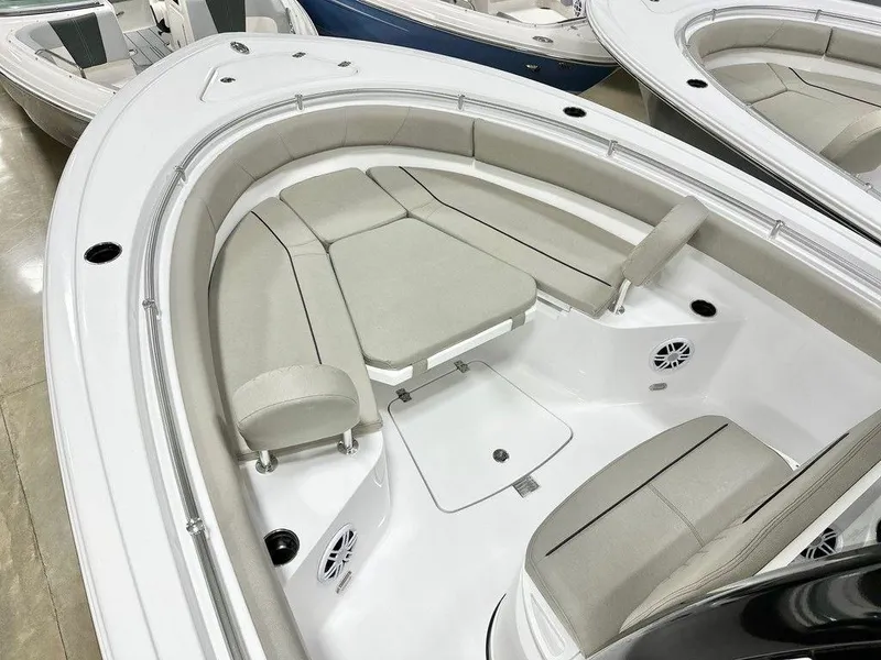 Slide: The Image of 2025 Sportsman Open 232 boat interior with cushioned seating and speakers. - 13
