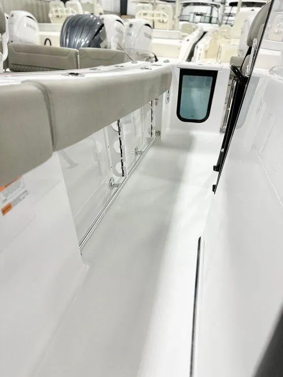 Slide: The Image of 2025 Sportsman Open 232 boat interior, featuring sleek white seating and modern design elements. - 14
