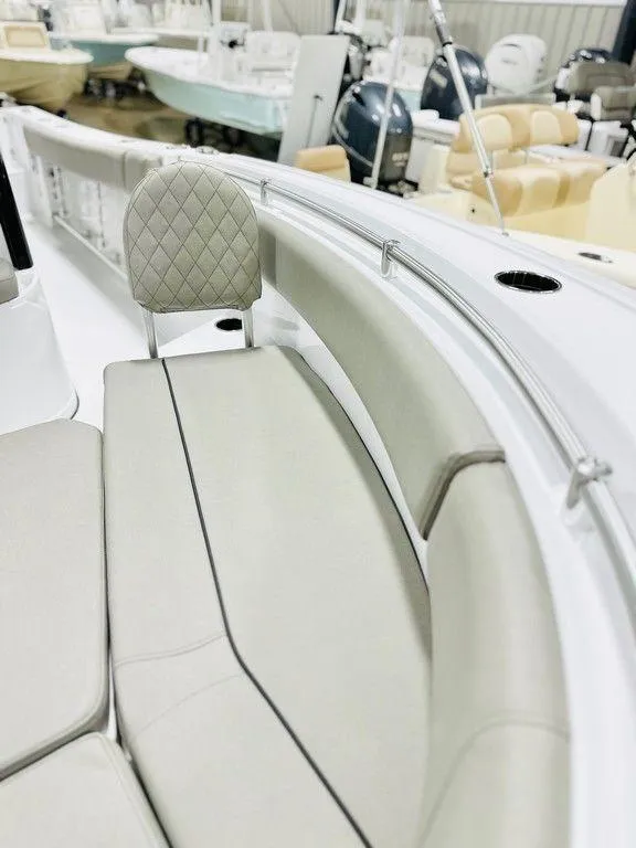 Slide: The Image of 2025 Sportsman Open 232 boat interior with cushioned seating and modern design. - 15