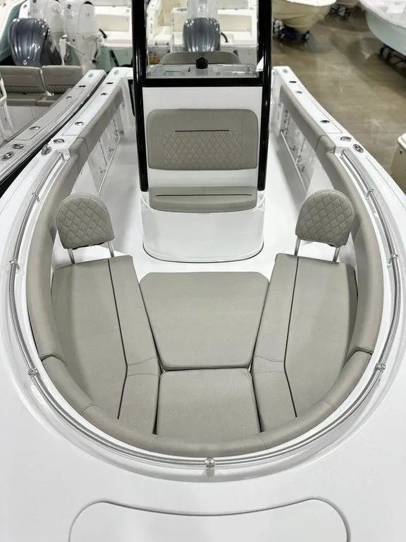 Slide: The Image of 2025 Sportsman Open 232 boat interior with cushioned seating and modern design. - 2