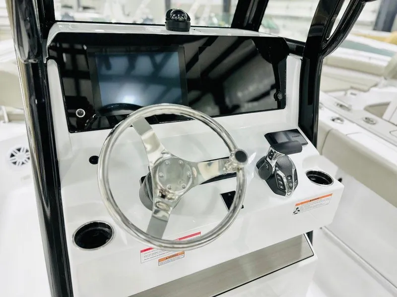 Slide: The Image of 2025 Sportsman Open 232 boat dashboard with steering wheel and controls. - 3