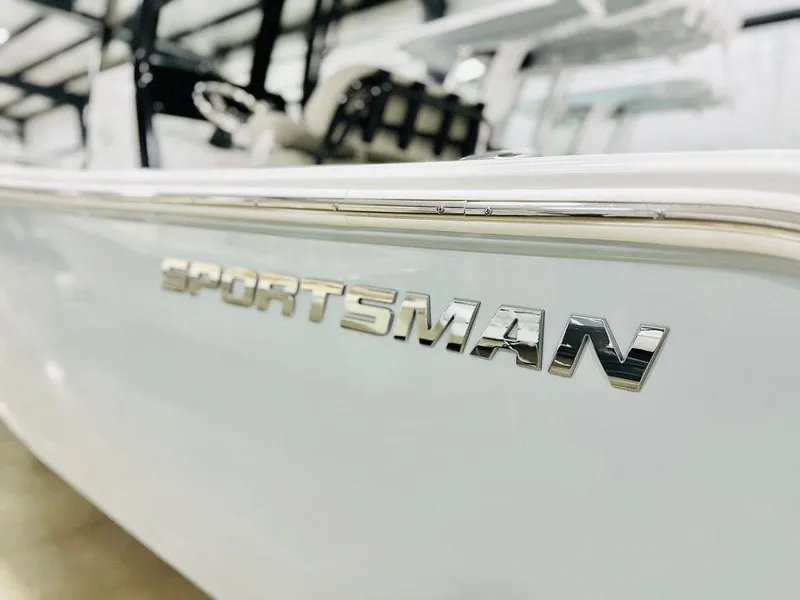 Slide: The Image of 2025 Sportsman Open 232 boat, close-up of logo on sleek white hull. - 6