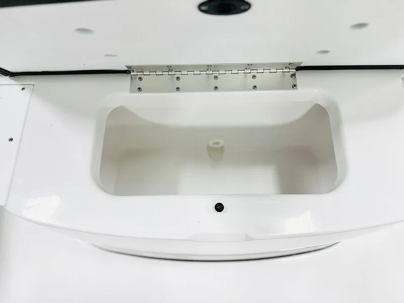 Slide: The Image of 2025 Sportsman Open 232 boat storage compartment, white interior, open lid. - 9