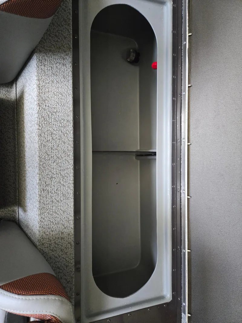 Slide: The Image of 2025 G3 Sportsman 1810 PFX boat interior storage compartment, gray with textured flooring. - 16