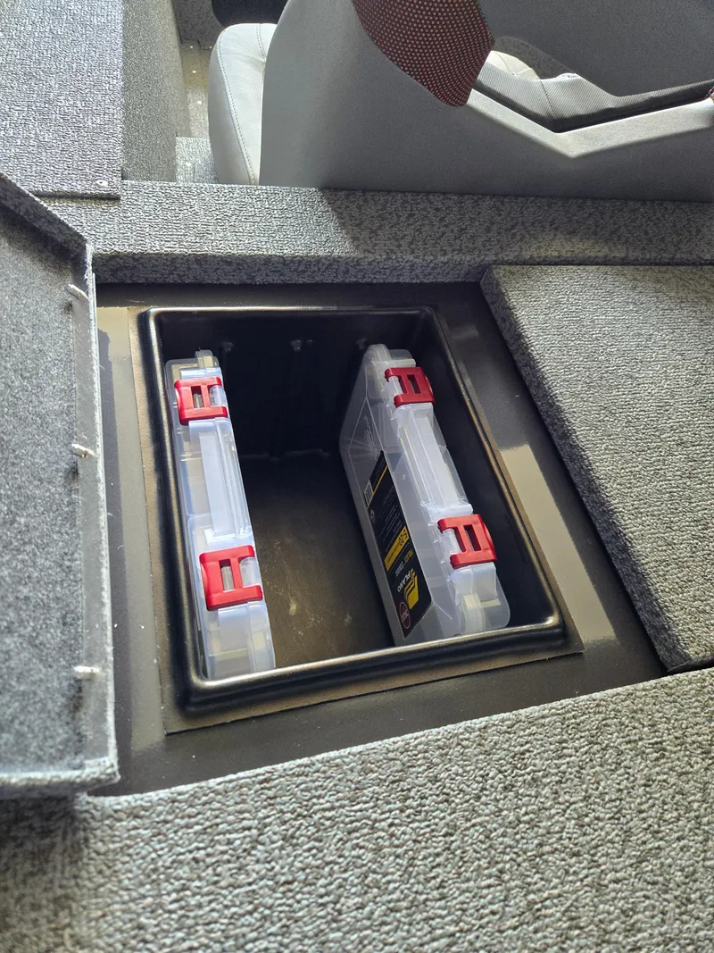 Slide: The Image of 2025 G3 Sportsman 1810 PFX storage compartment with tackle boxes. - 17