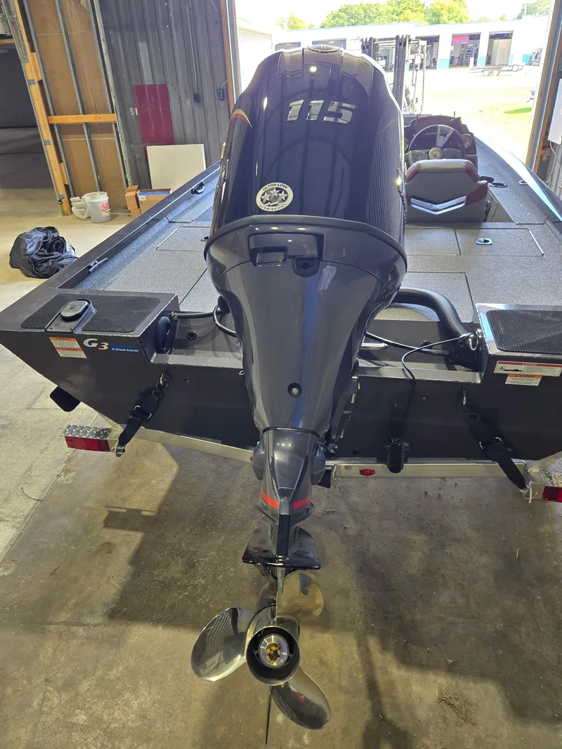 Slide: The Image of 2025 G3 Sportsman 1810 PFX boat with powerful outboard motor in a garage setting. - 3