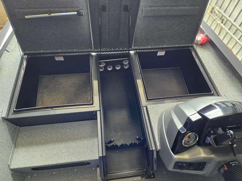 Slide: The Image of 2025 G3 Sportsman 1810 PFX boat interior with open storage compartments and control panel. - 9