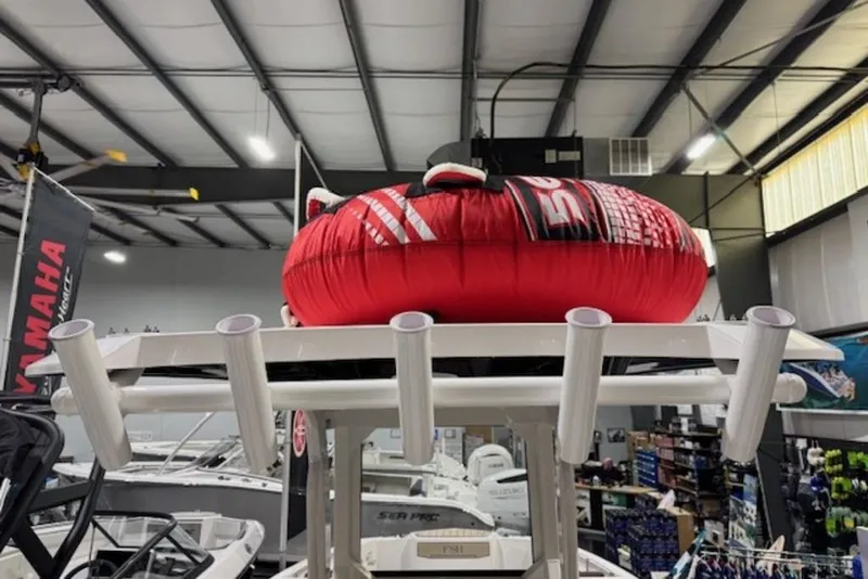 Slide: The Image of 2025 Yamaha Boats 252 FSH Sport with red inflatable tube in showroom. - 13