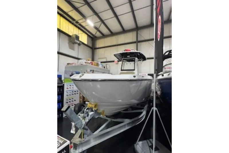 Slide: The Image of 2025 Yamaha Boats 252 FSH Sport displayed indoors on a trailer. - 2