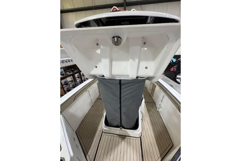 Slide: The Image of 2025 Yamaha Boats 252 FSH Sport interior with open storage compartment. - 8