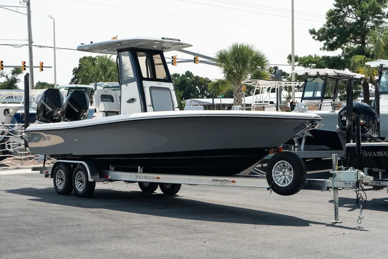 The Image of 2025 ShearWater 27 Carolina Open boat on trailer, parked outdoors. - 1