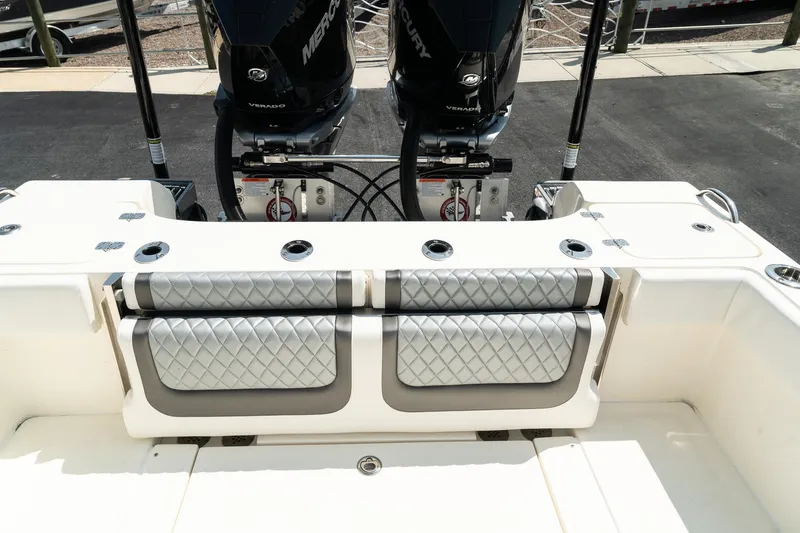 Slide: The Image of 2025 ShearWater 27 Carolina Open boat with dual Mercury engines and cushioned seating. - 11